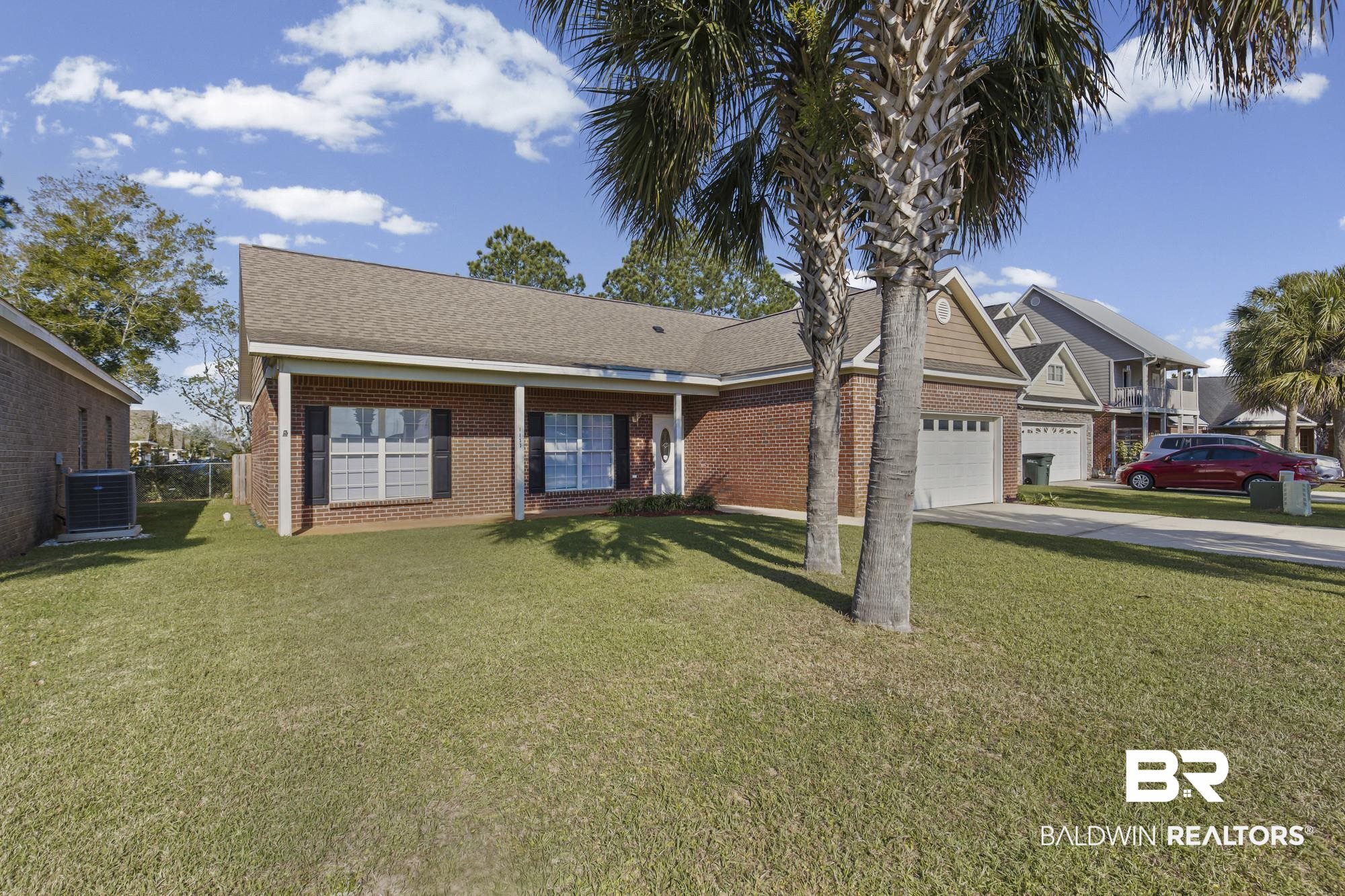 1153 Sloane Cove Foley, AL 36535 - Photo 4 of 25 View of front of home with a front yard, brick siding, a garage, concrete driveway, and roof with shingles