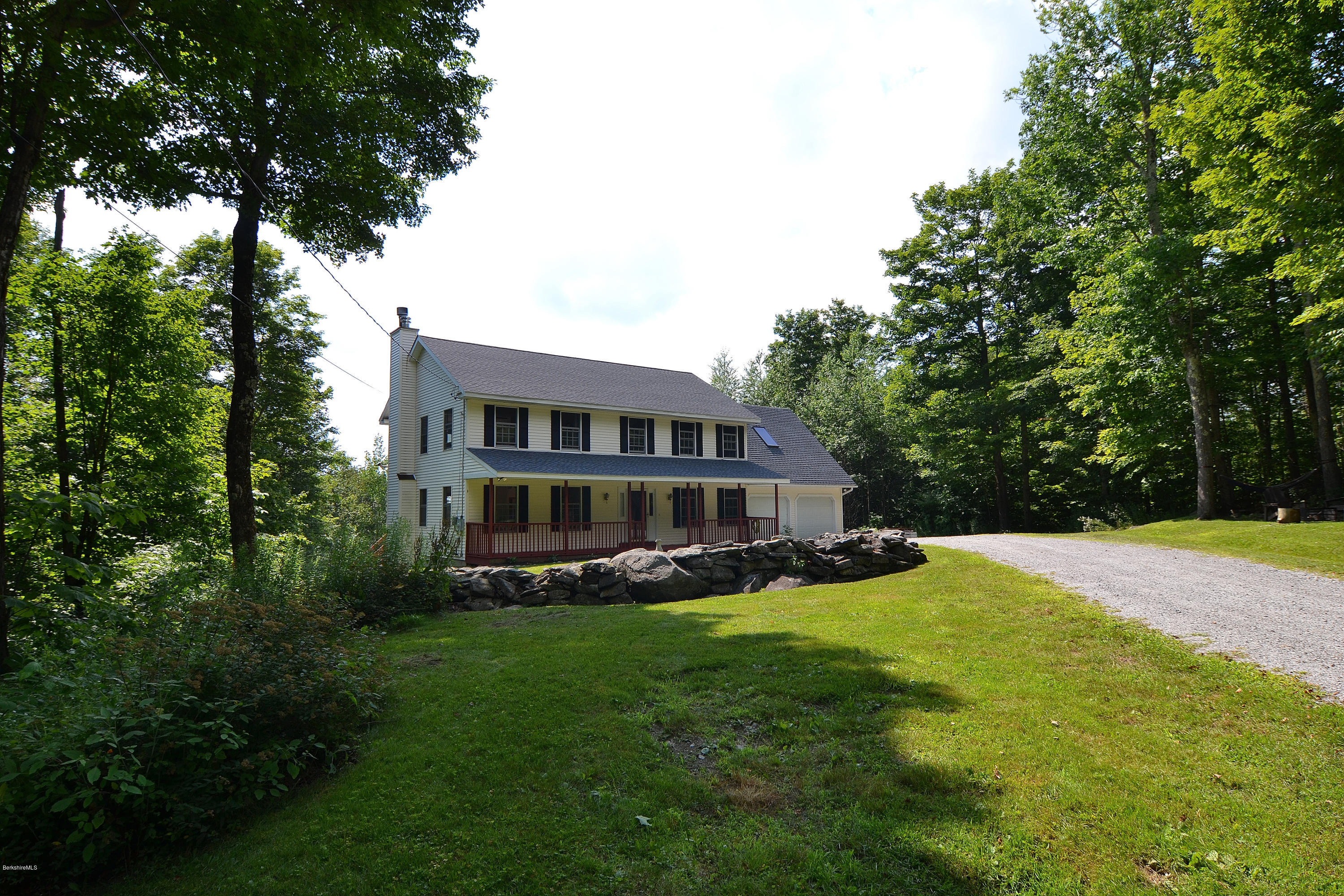693 George Carter Road Becket, MA 01223 - Photo 1 of 36 a view of a house with a big yard and large trees