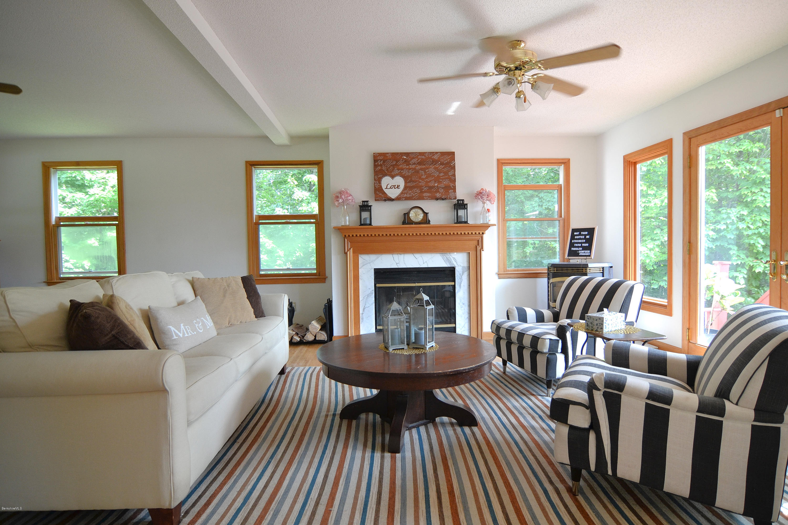 693 George Carter Road Becket, MA 01223 - Photo 2 of 36 a living room with furniture a fireplace and a large window