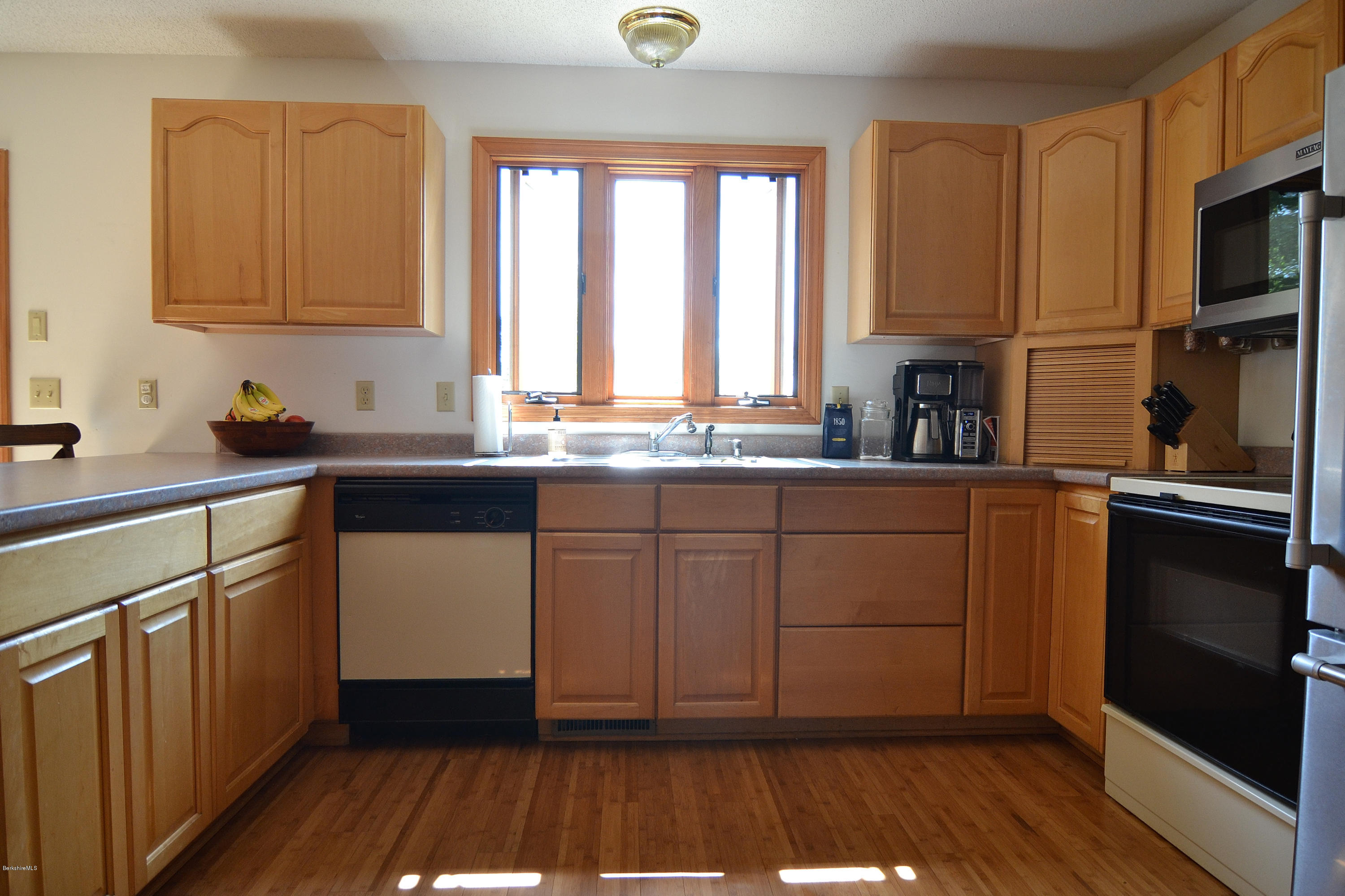 693 George Carter Road Becket, MA 01223 - Photo 11 of 36 a kitchen with a sink a window and cabinets