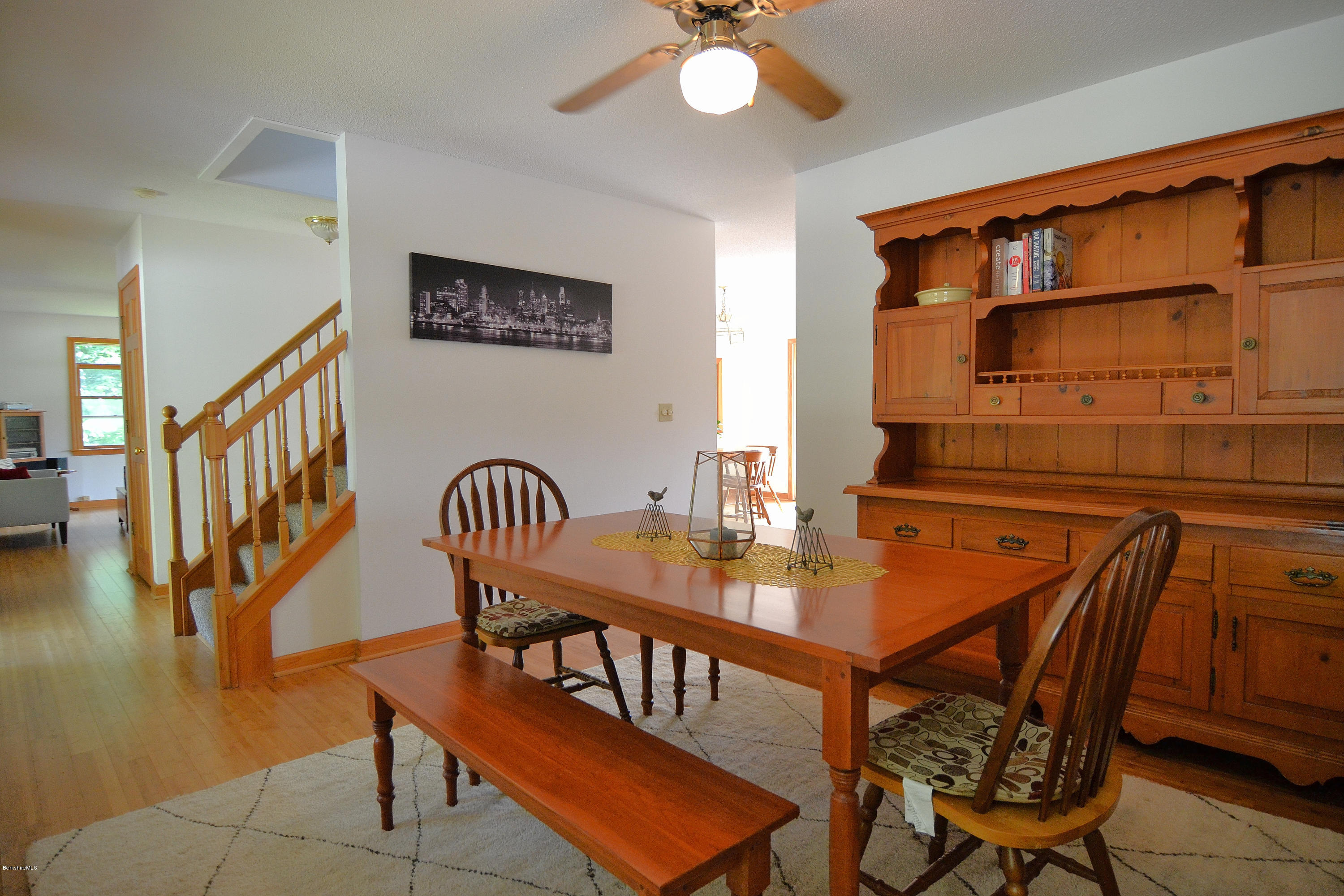 693 George Carter Road Becket, MA 01223 - Photo 12 of 36 a dining room with furniture and wooden floor