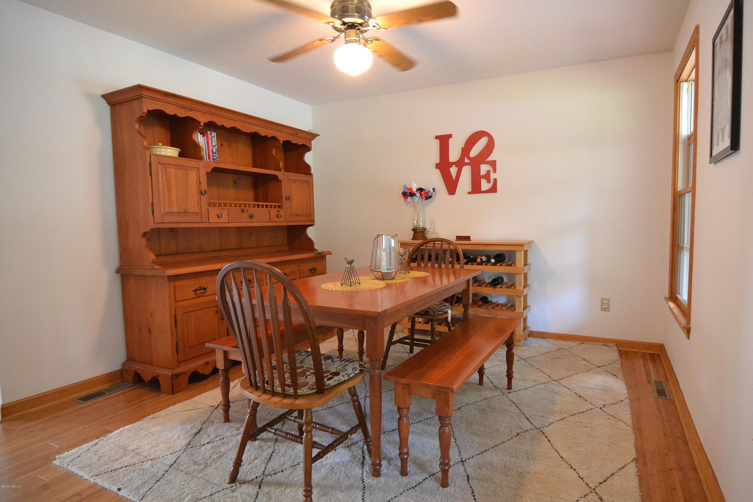 693 George Carter Road Becket, MA 01223 - Photo 13 of 36 a view of a dining room with furniture and chandelier
