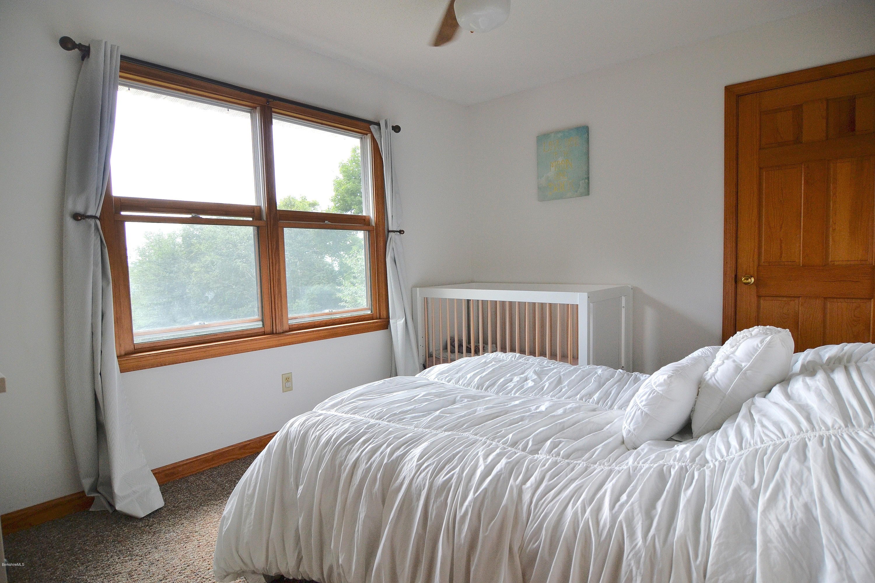 693 George Carter Road Becket, MA 01223 - Photo 18 of 36 a bedroom with a bed and a window