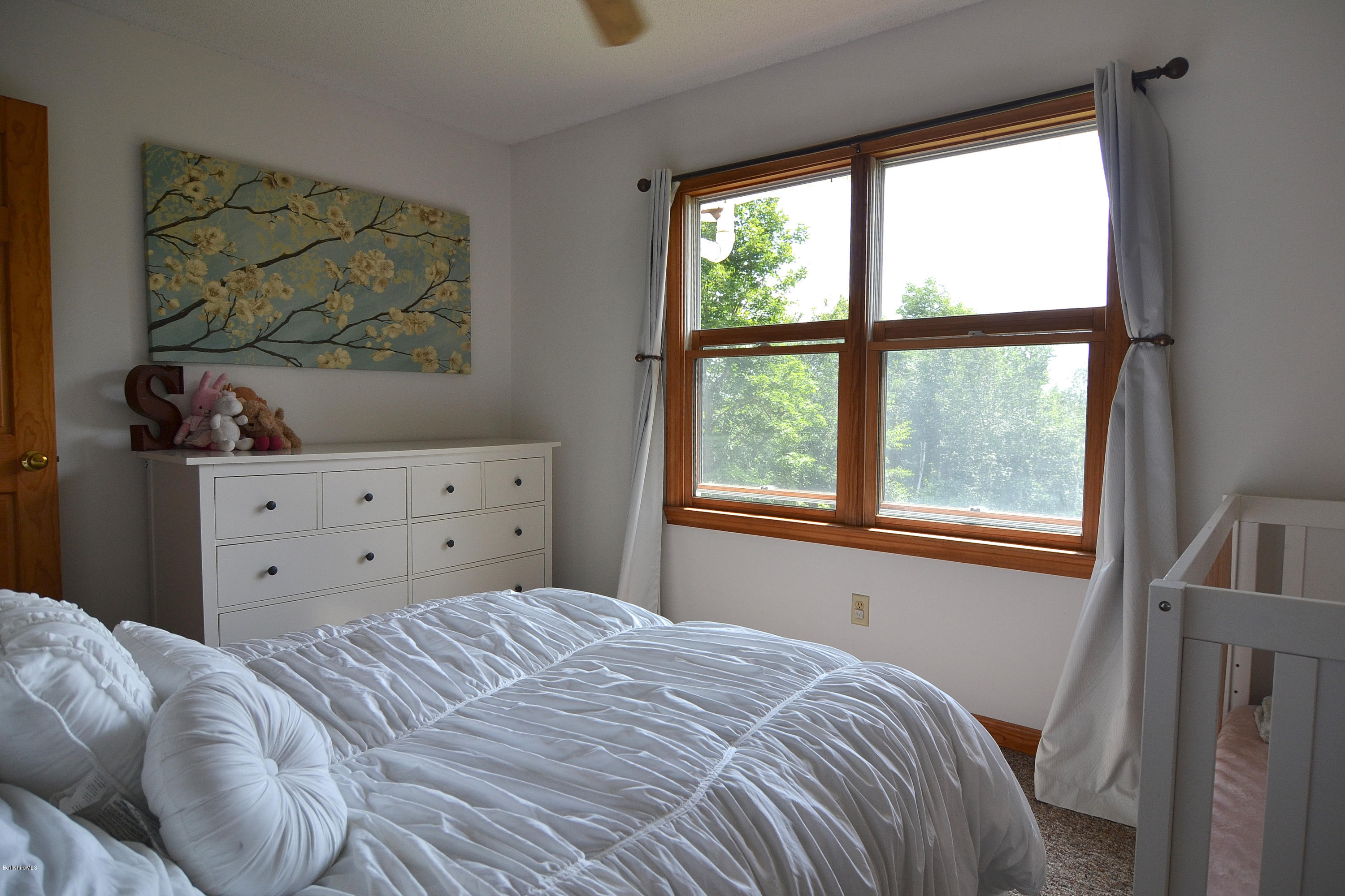 693 George Carter Road Becket, MA 01223 - Photo 19 of 36 a bedroom with a bed and a window