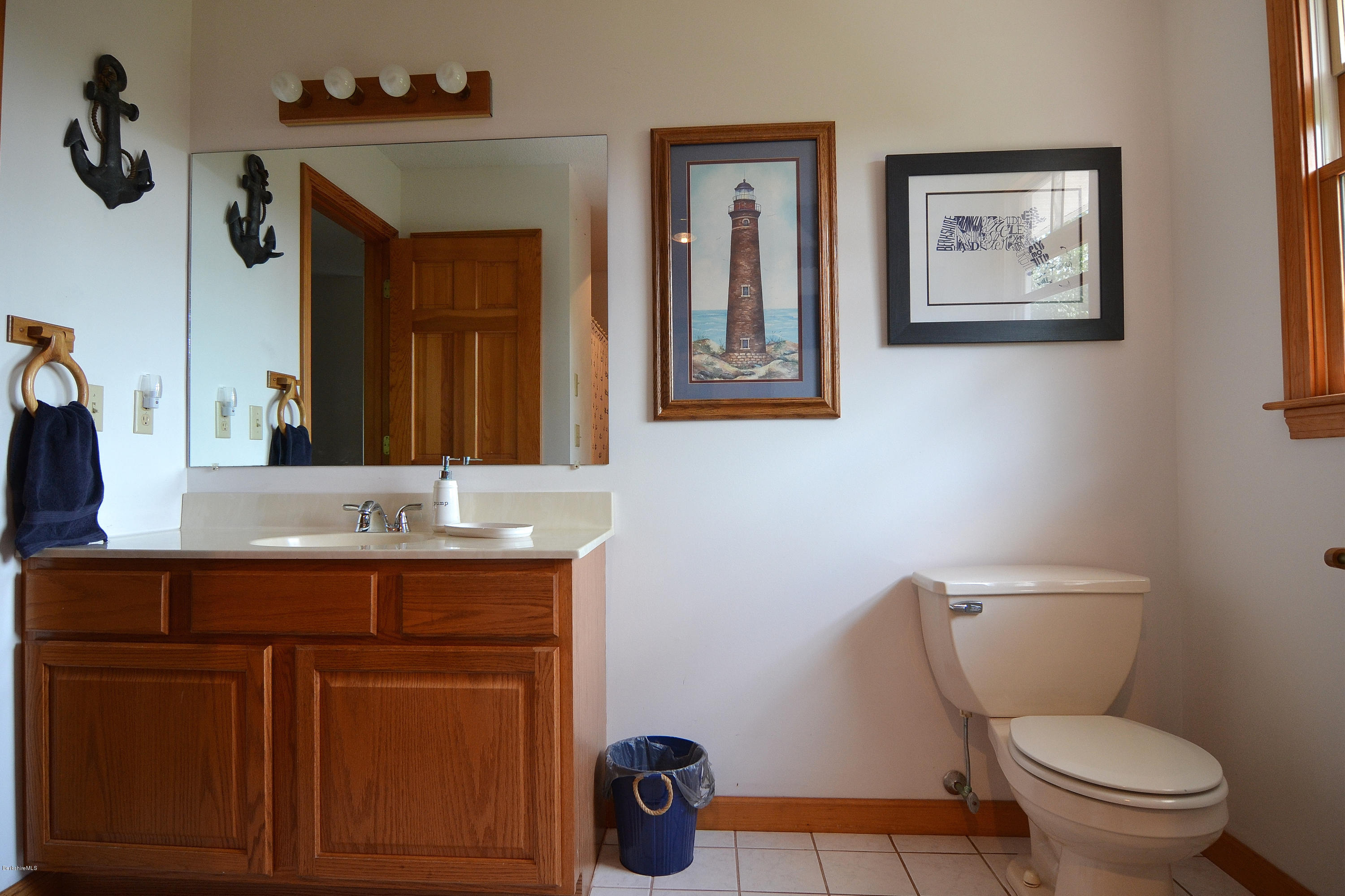 693 George Carter Road Becket, MA 01223 - Photo 23 of 36 a bathroom with a toilet a sink and mirror