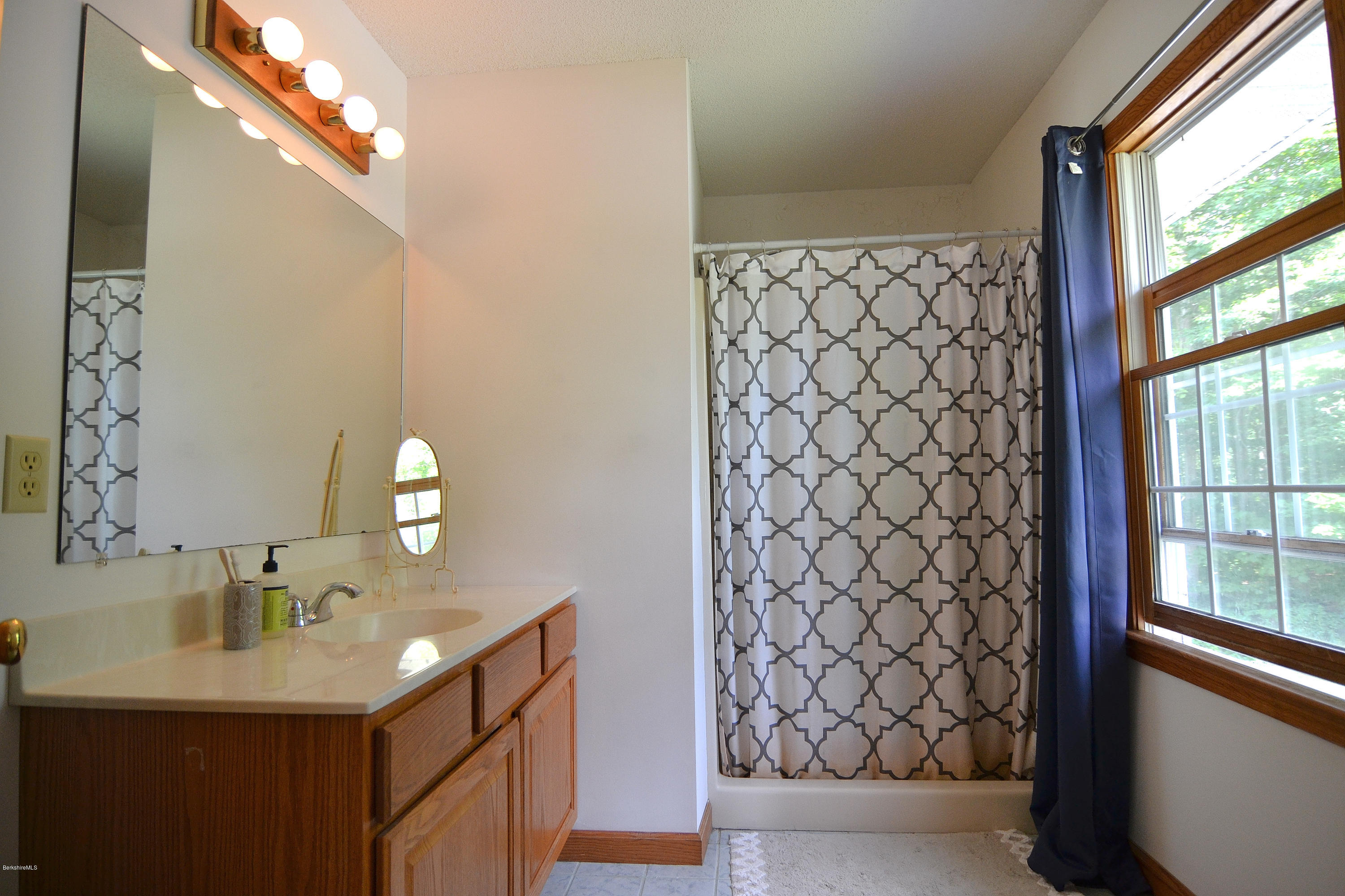 693 George Carter Road Becket, MA 01223 - Photo 28 of 36 a bathroom with a sink vanity granite and a mirror