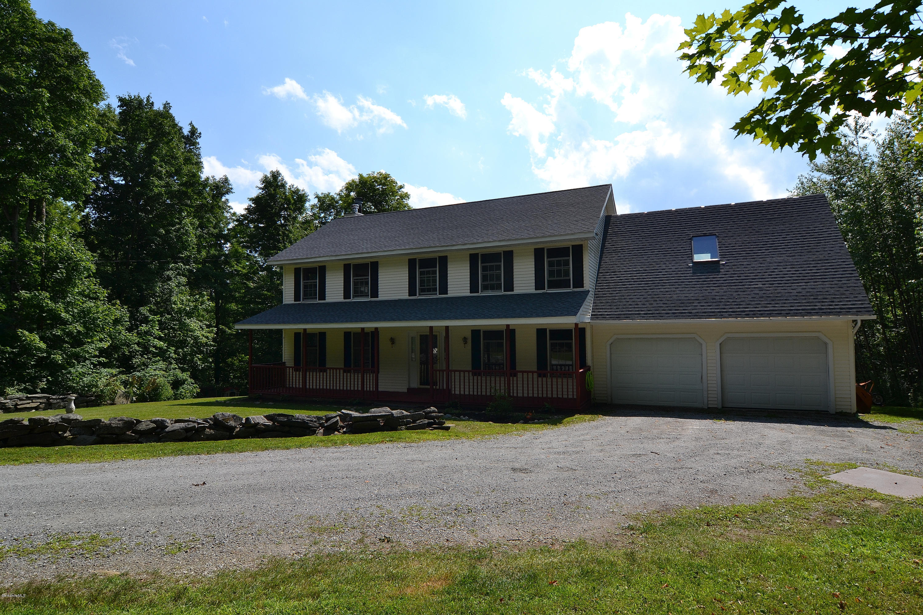 693 George Carter Road Becket, MA 01223 - Photo 32 of 36 a front view of a house with a yard and garage