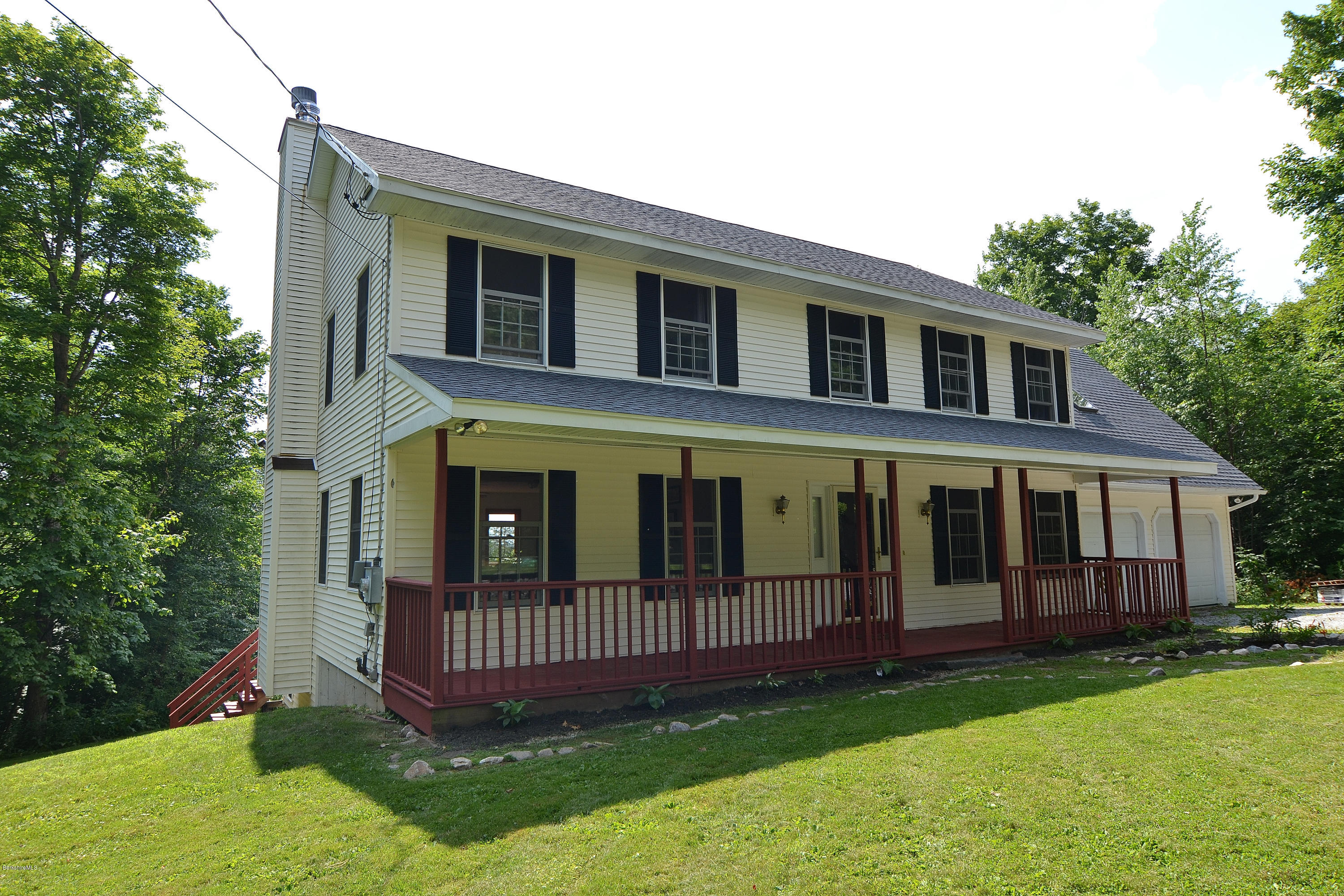 693 George Carter Road Becket, MA 01223 - Photo 36 of 36 a view of a house with a yard and deck