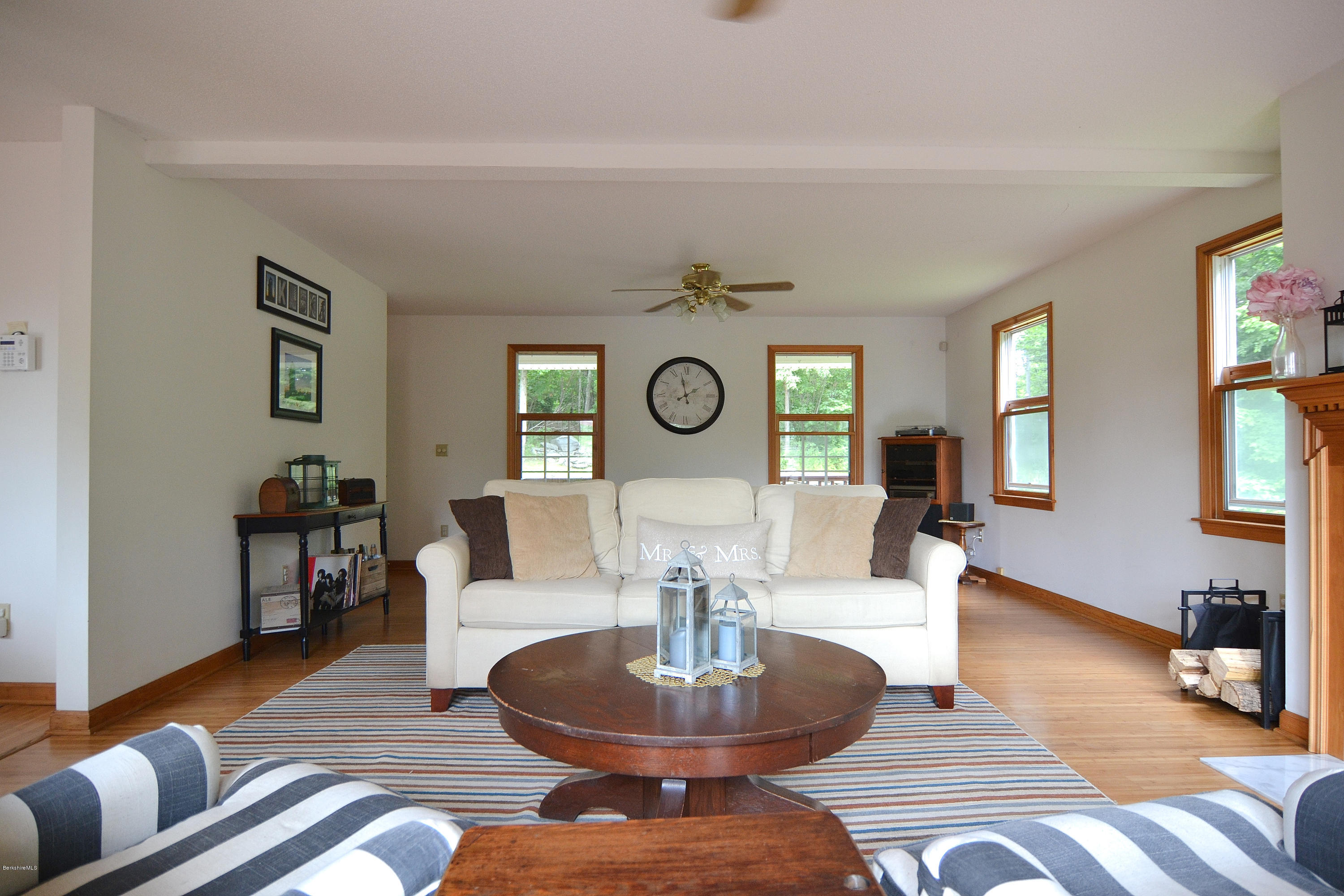 693 George Carter Road Becket, MA 01223 - Photo 5 of 36 a living room with fireplace furniture and a wooden floor