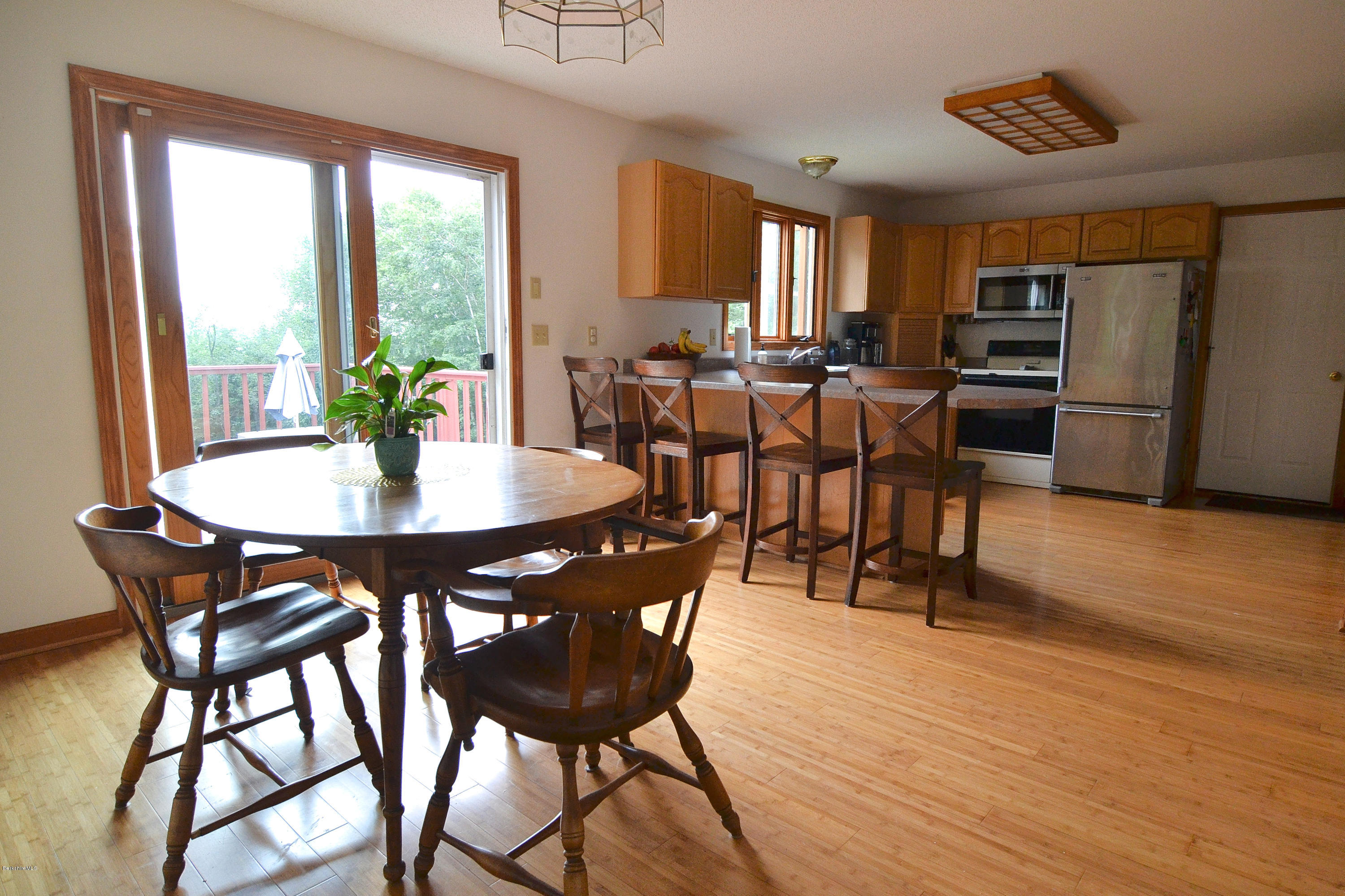 693 George Carter Road Becket, MA 01223 - Photo 9 of 36 a view of a dining room with furniture window and wooden floor
