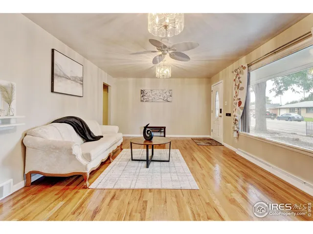 a living room with furniture and a floor to ceiling window