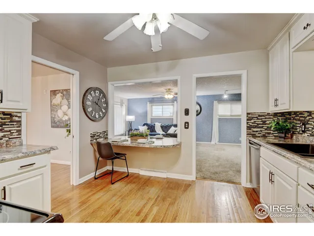 a living room with furniture and a kitchen view