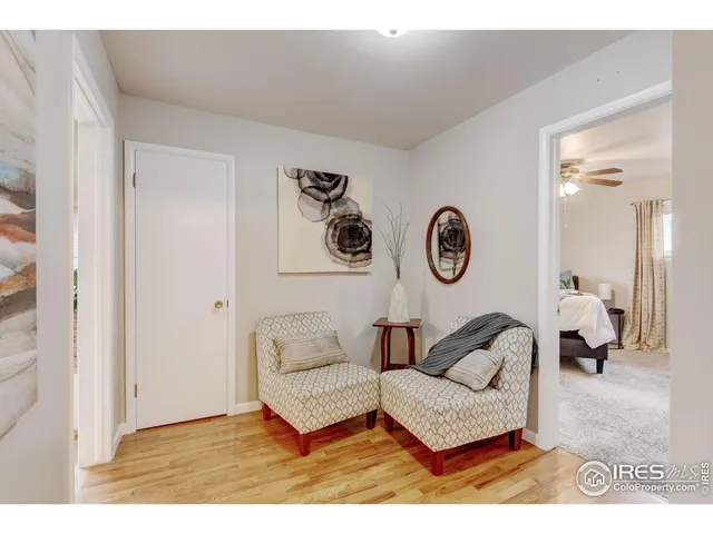 a living room with furniture and a wall painting