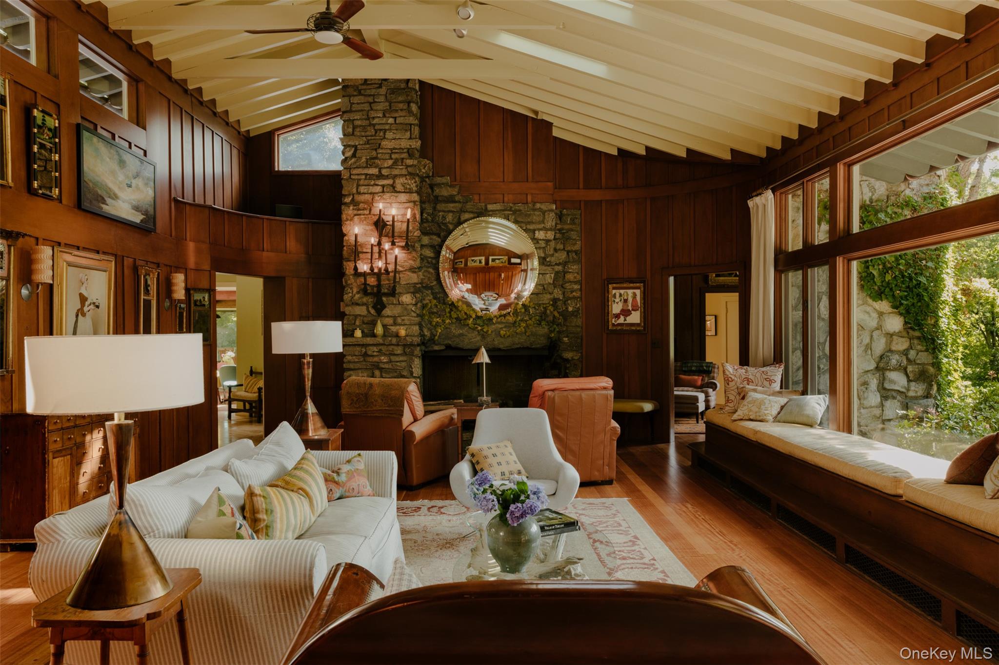 481 Old Albany Post Road Garrison, NY 10524 - Photo 5 of 29 Spacious living area featuring a stone fireplace, soaring windows, gently curving wood paneled walls and a vaulted ceiling with exposed beams