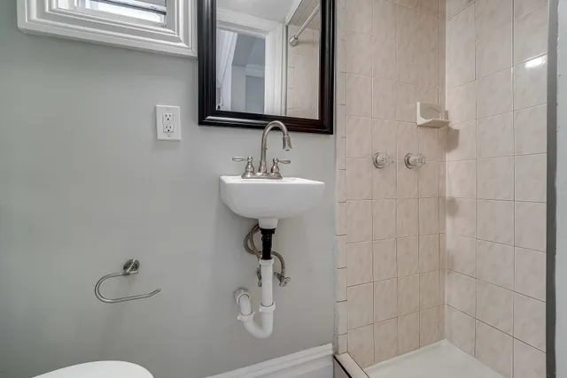 a bathroom with a sink a toilet and mirror