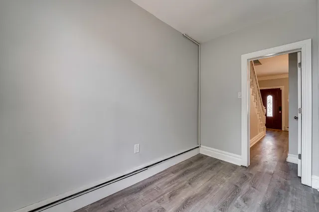 a view of a room with wooden floor