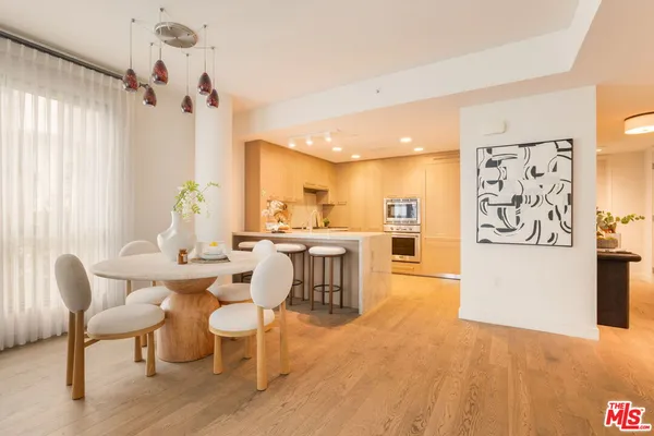a large kitchen with a table and chairs