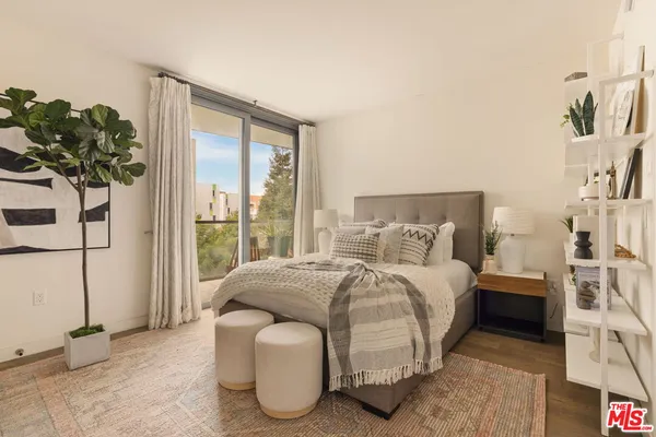 a bedroom with a bed and a potted plant