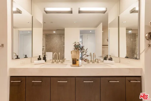 a bathroom with a double vanity sink mirror and double