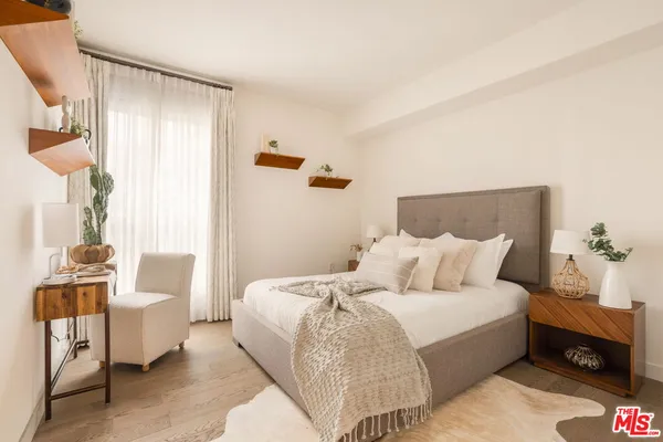 a bedroom with a bed and a couch
