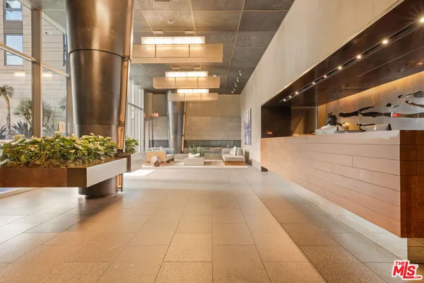 a lobby with furniture and a chandelier