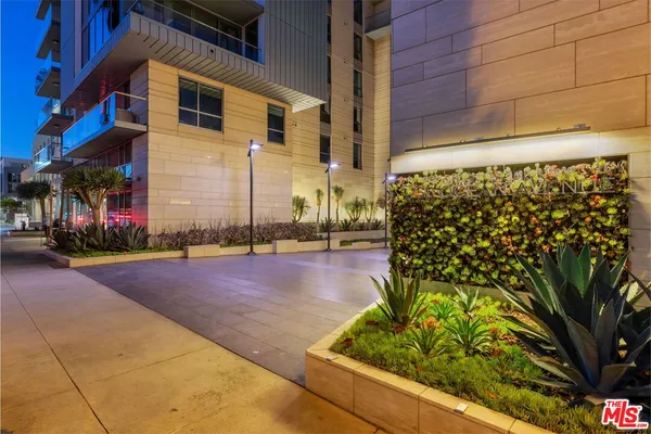 a view of a street with potted plants