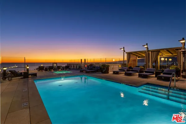 a view of a swimming pool and lounge chairs
