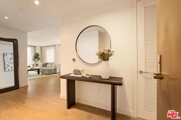 a living room with furniture a table and a mirror