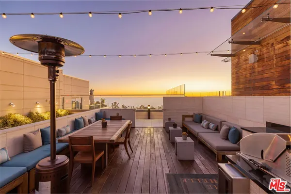 a view of a terrace with furniture and a table