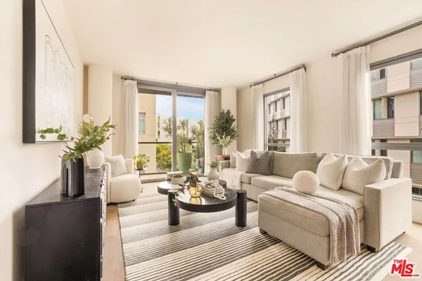 a living room with furniture and large windows