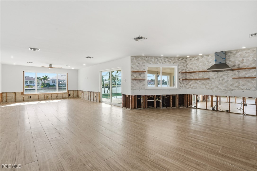 380 Conners Avenue Naples, FL 34108 - Photo 12 of 49 a view of an ocean & kitchen with furniture wooden floor and windows