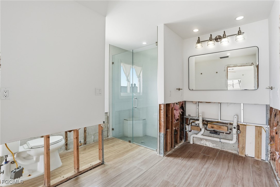 380 Conners Avenue Naples, FL 34108 - Photo 19 of 49 a view of a hallway with wooden floor and furniture