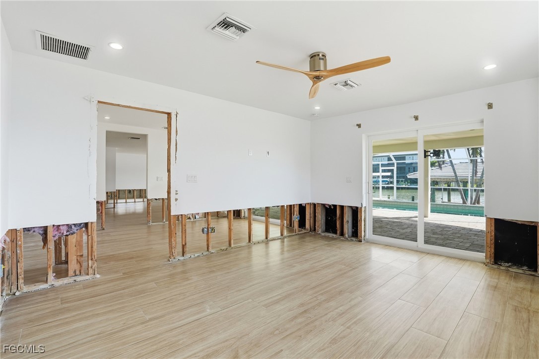 380 Conners Avenue Naples, FL 34108 - Photo 20 of 49 a view of an empty room with wooden floor and a window