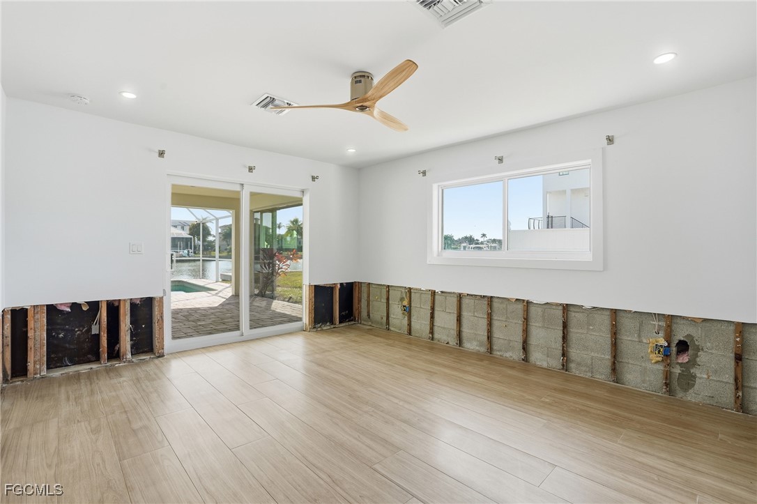 380 Conners Avenue Naples, FL 34108 - Photo 21 of 49 a view of an empty room with wooden floor and a window