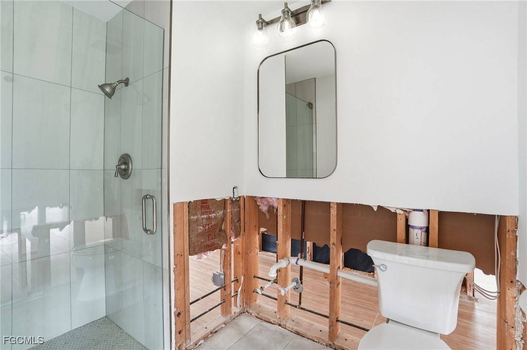 380 Conners Avenue Naples, FL 34108 - Photo 22 of 49 a bathroom with a glass shower door