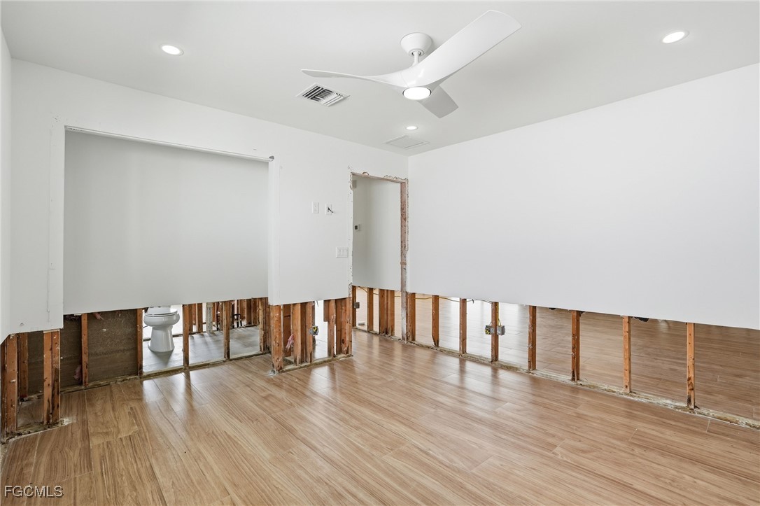 380 Conners Avenue Naples, FL 34108 - Photo 24 of 49 a view of an empty room with wooden floor