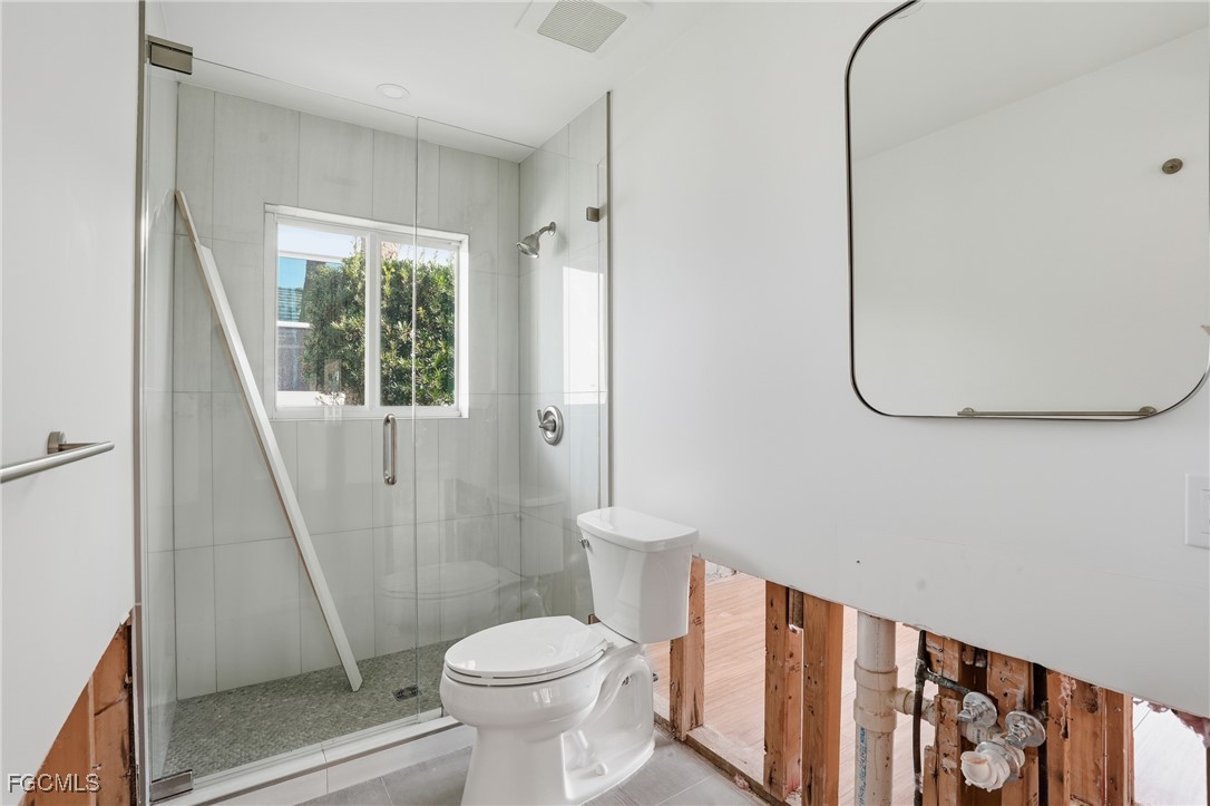 380 Conners Avenue Naples, FL 34108 - Photo 25 of 49 a bathroom with a toilet and a shower