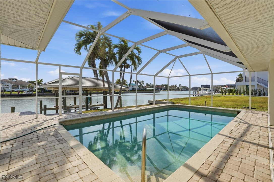 380 Conners Avenue Naples, FL 34108 - Photo 34 of 49 a view of a swimming pool with a patio