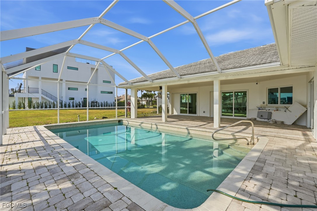 380 Conners Avenue Naples, FL 34108 - Photo 37 of 49 a view of a swimming pool with a patio