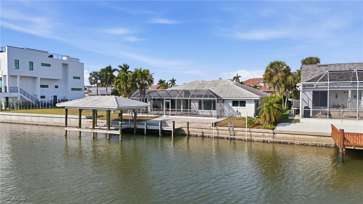 380 Conners Avenue Naples, FL 34108 - Photo 46 of 49 a view of a house with pool and chairs