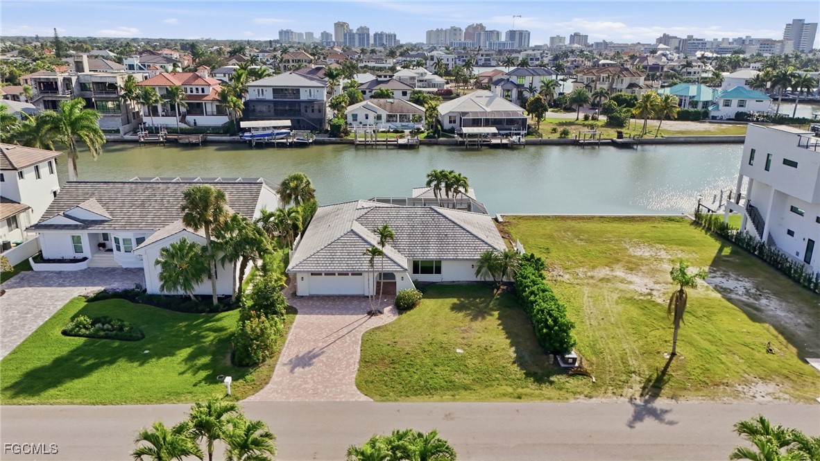 380 Conners Avenue Naples, FL 34108 - Photo 8 of 49 an aerial view of a house with a lake view