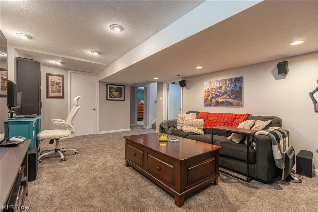 8320 Ackley Road Parma, OH 44129 - Photo 20 of 36 Carpeted living room with a textured ceiling