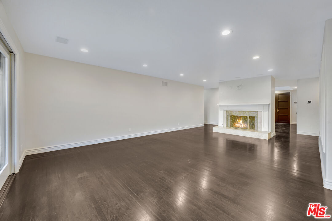 2169 Hercules Drive Los Angeles, CA 90046 - Photo 13 of 29 a view of an empty room with wooden floor and a window