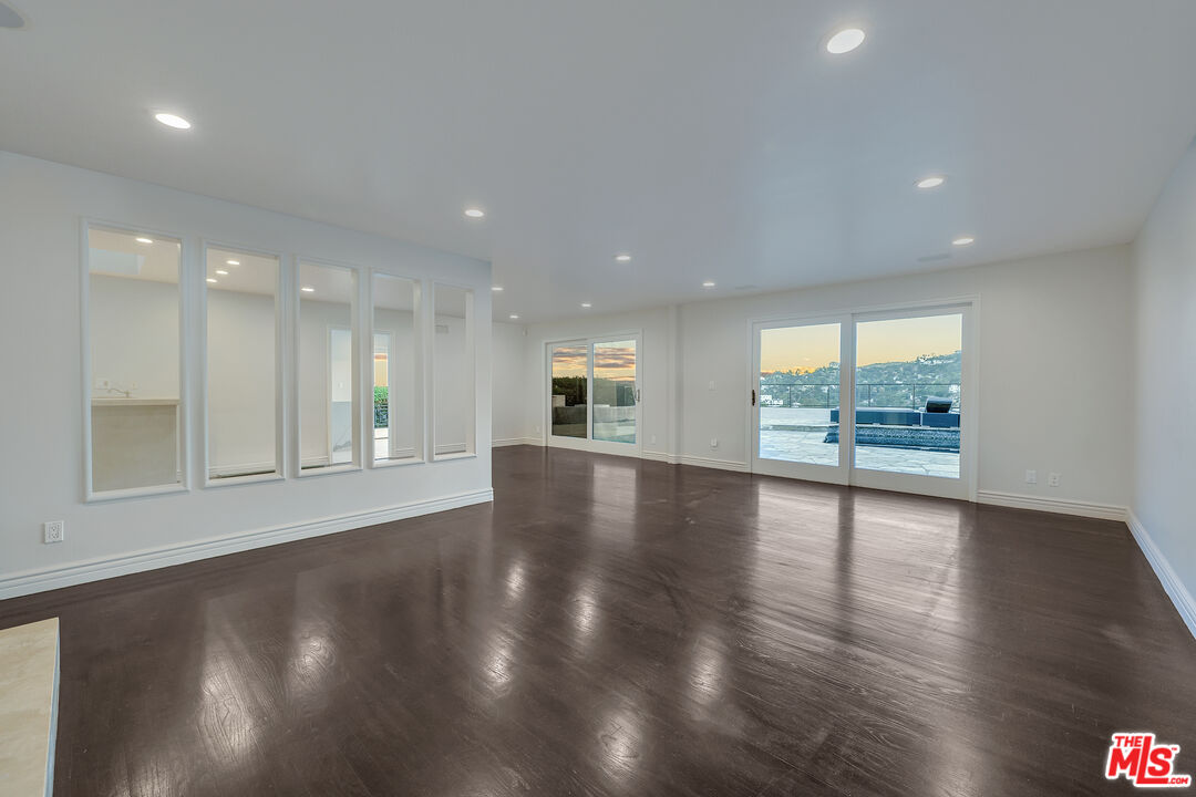 2169 Hercules Drive Los Angeles, CA 90046 - Photo 14 of 29 a view of an empty room with wooden floor and a window