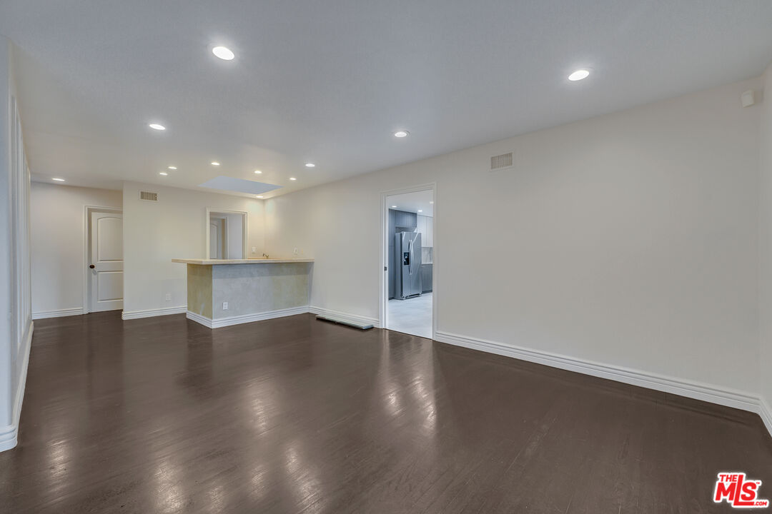 2169 Hercules Drive Los Angeles, CA 90046 - Photo 15 of 29 a view of an empty room with wooden floor and staircase