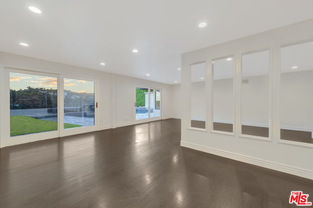 2169 Hercules Drive Los Angeles, CA 90046 - Photo 16 of 29 a view of an empty room with wooden floor and a window