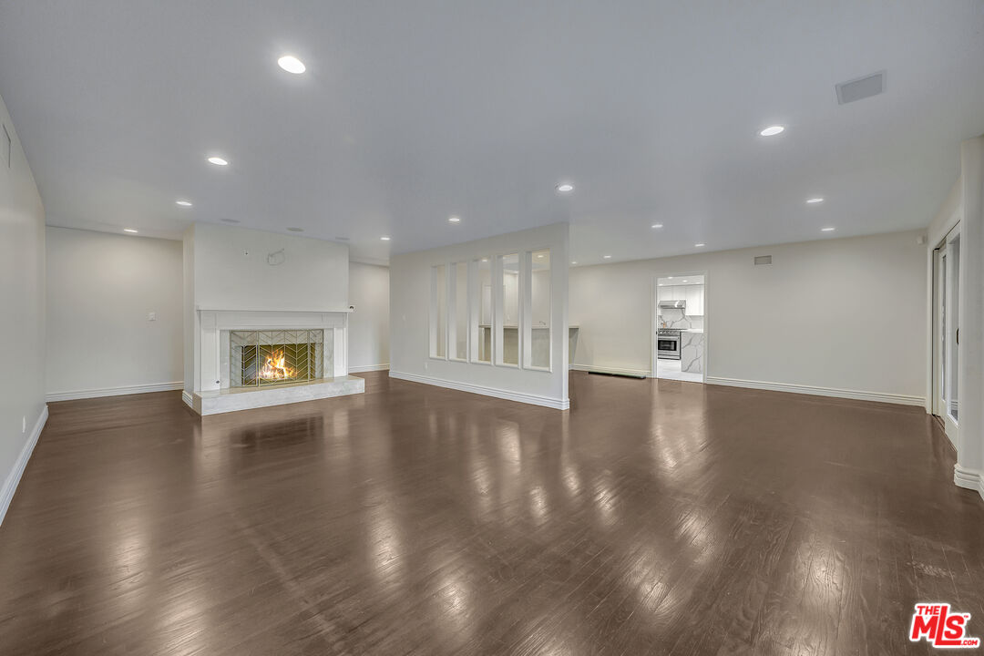 2169 Hercules Drive Los Angeles, CA 90046 - Photo 17 of 29 a view of an empty room with wooden floor and a window