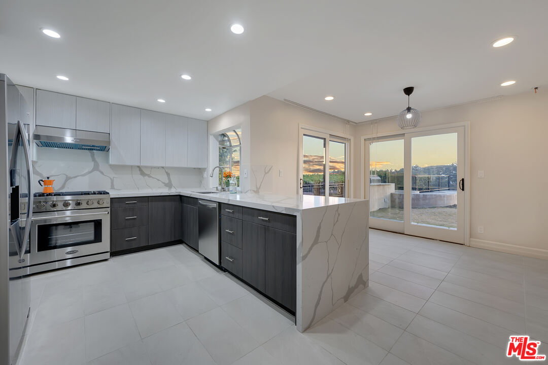 2169 Hercules Drive Los Angeles, CA 90046 - Photo 9 of 29 a kitchen with stainless steel appliances granite countertop a stove and a sink