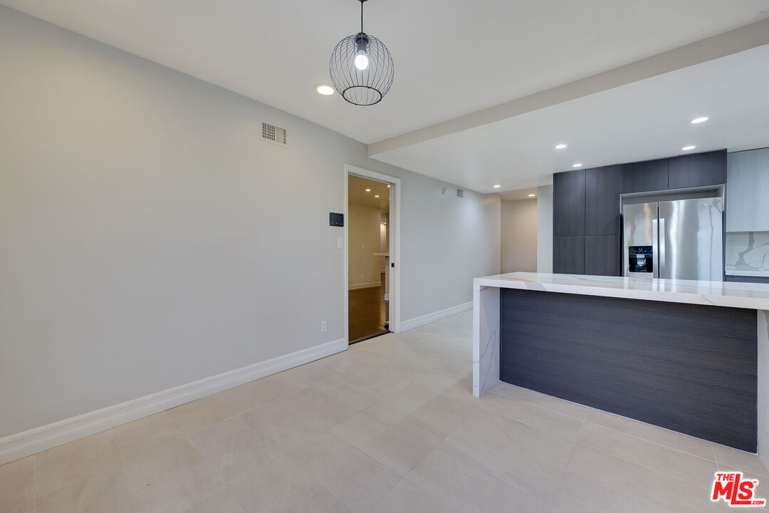 2169 Hercules Drive Los Angeles, CA 90046 - Photo 10 of 29 an empty room with kitchen view and wooden floor