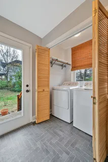 a utility room with cabinets dryer and washer